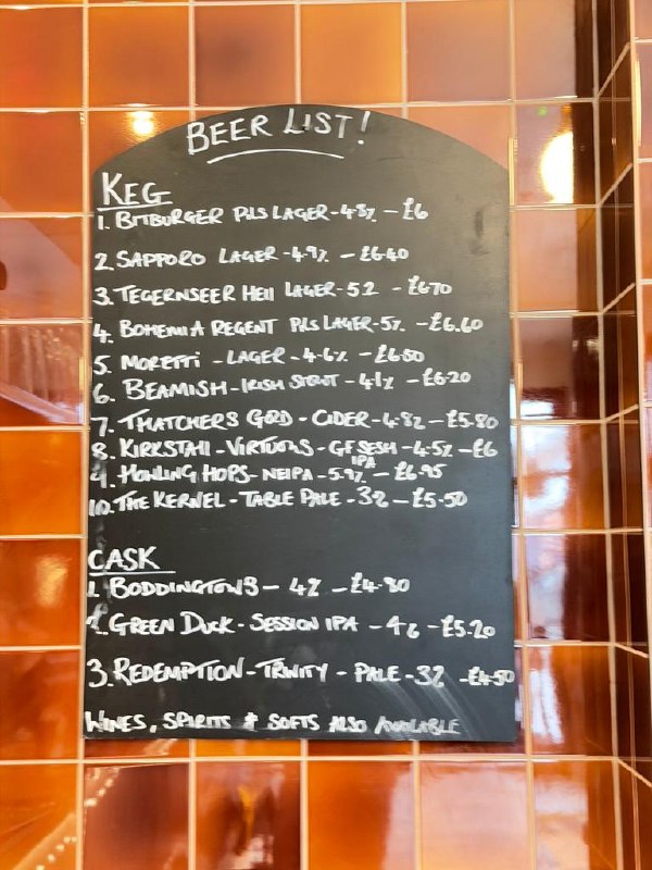 Beer list chalkboard at The Whippet, launch week mid-May 2026: ten keg lines including Bitburger, Sapporo, Tegernseer Hell, Bohemia Regent and Moretti, plus three cask handpulls